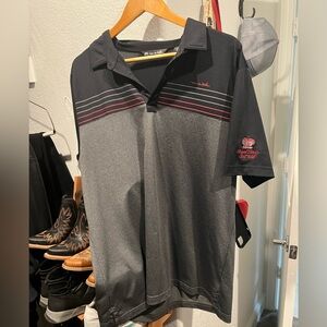 Travis Mathew black and gray polo with red stripes.